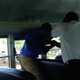 Cellphone footage shows a bus driver restraining a 13-year-old boy against the windows of a school bus. (Local 10 screenshot)